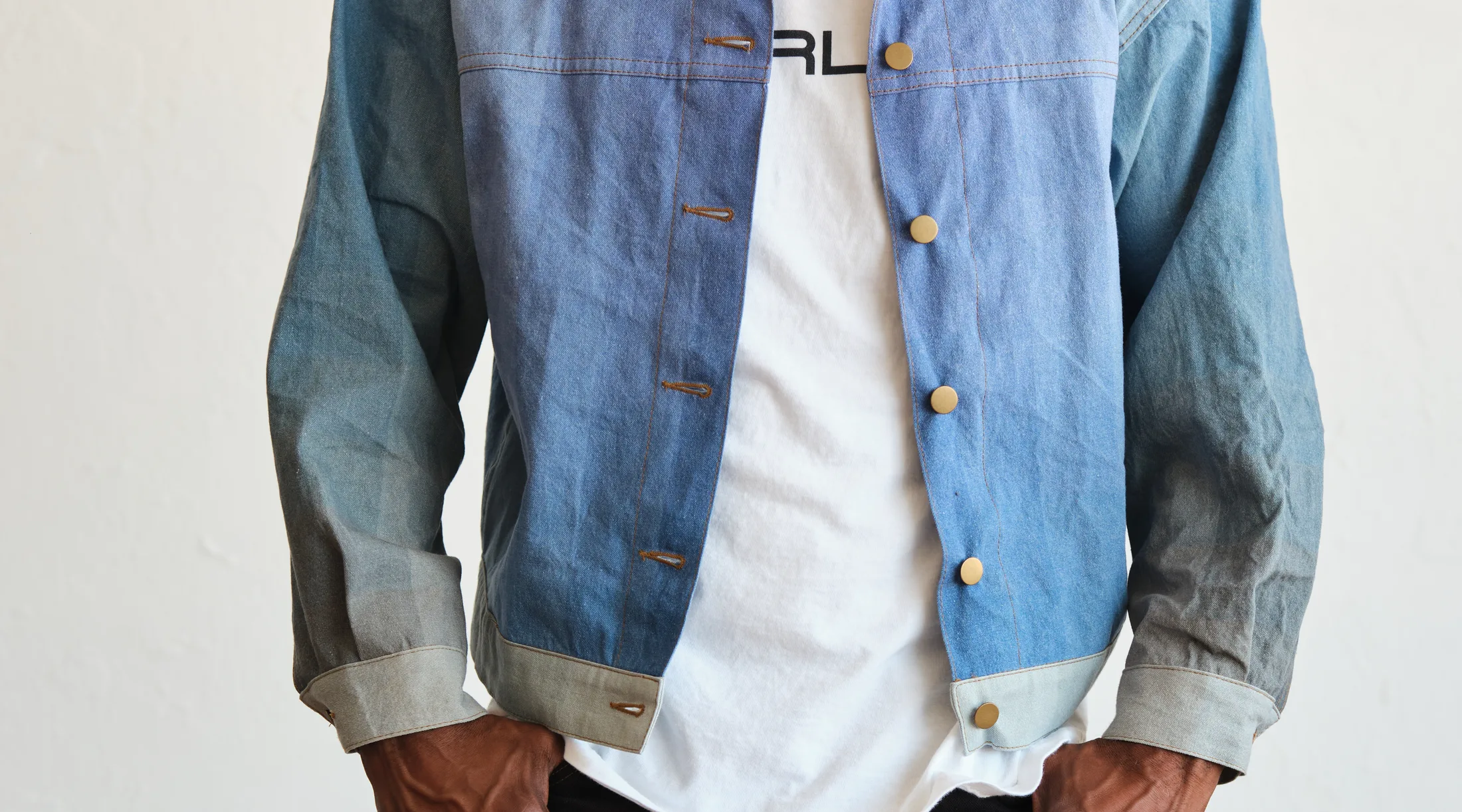 WTRLSS multi-tonal denim jacket front — light-to-dark tonal panels and brass buttons from one dry pass