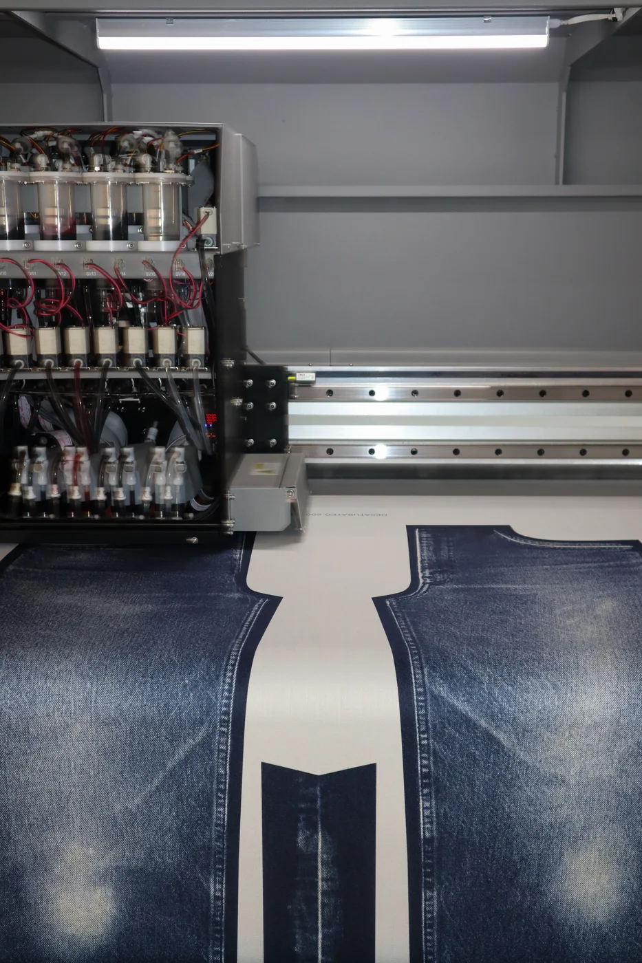 The WTRLSS print head and bio-ink station over freshly printed denim