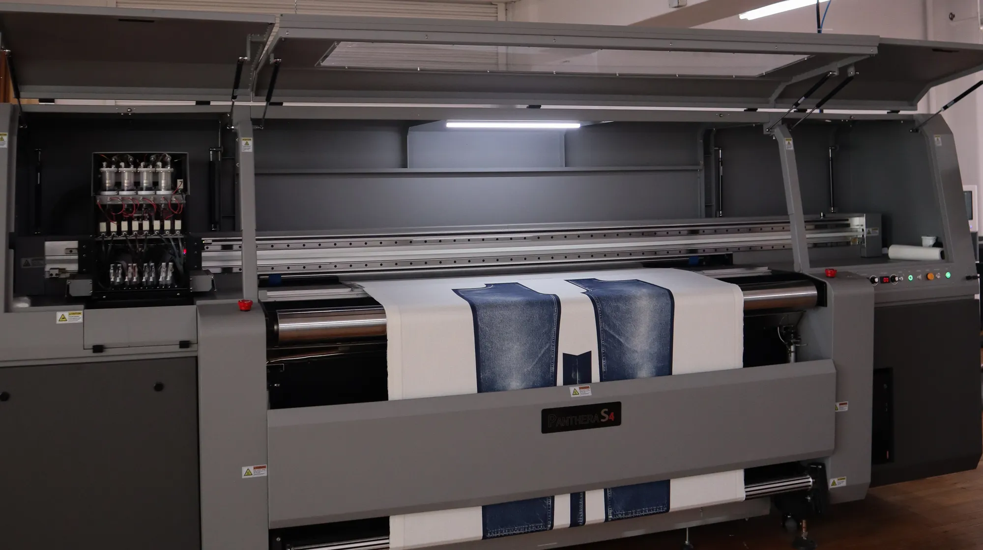 The WTRLSS Panthera S4 machine printing denim panels on the factory floor