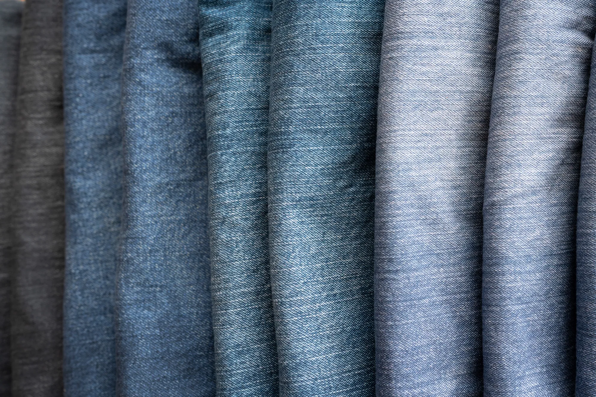 Vertical range of WTRLSS denim washes, black to indigo