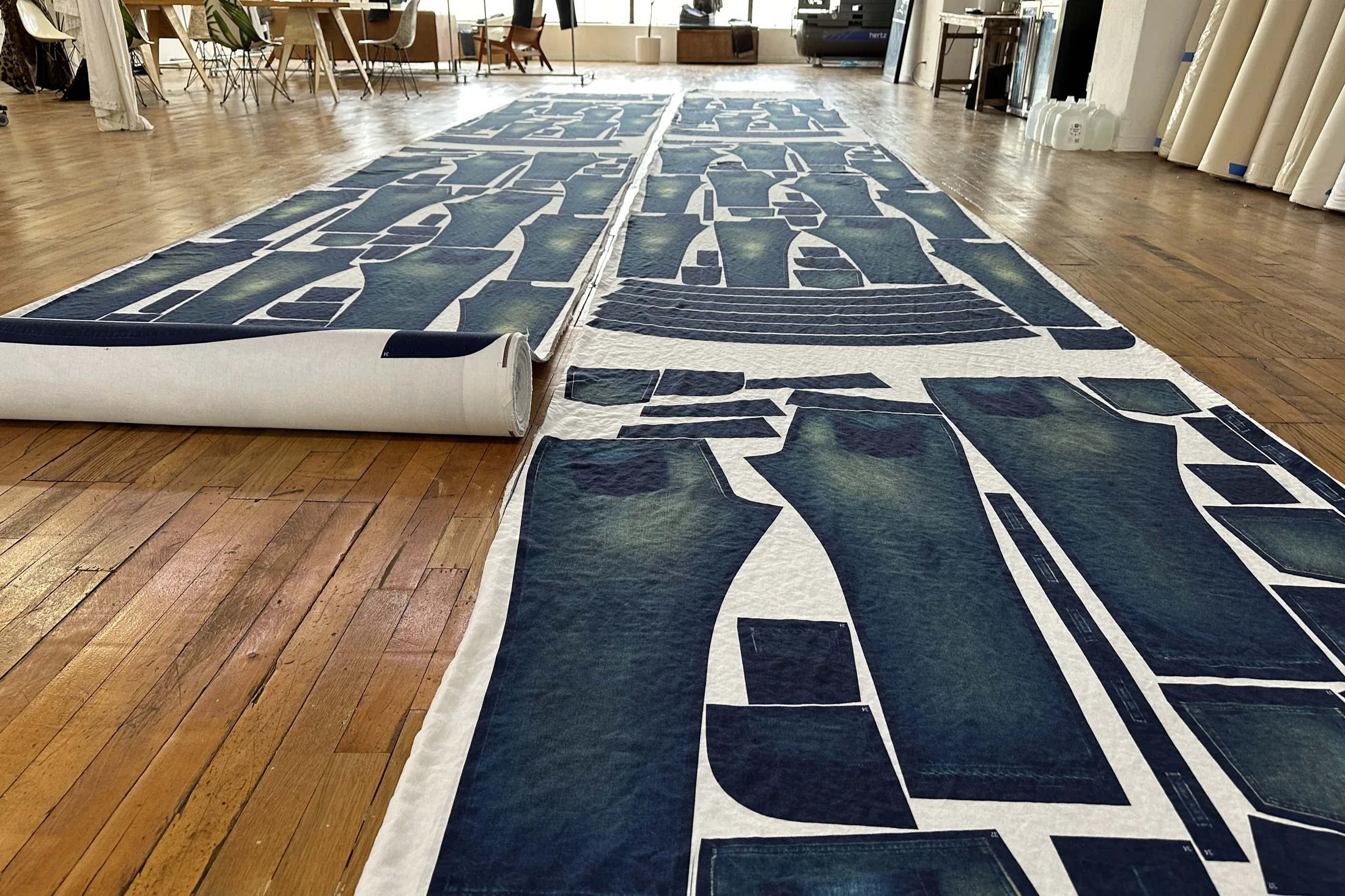 WTRLSS-printed denim panels laid out across the studio floor — production at scale