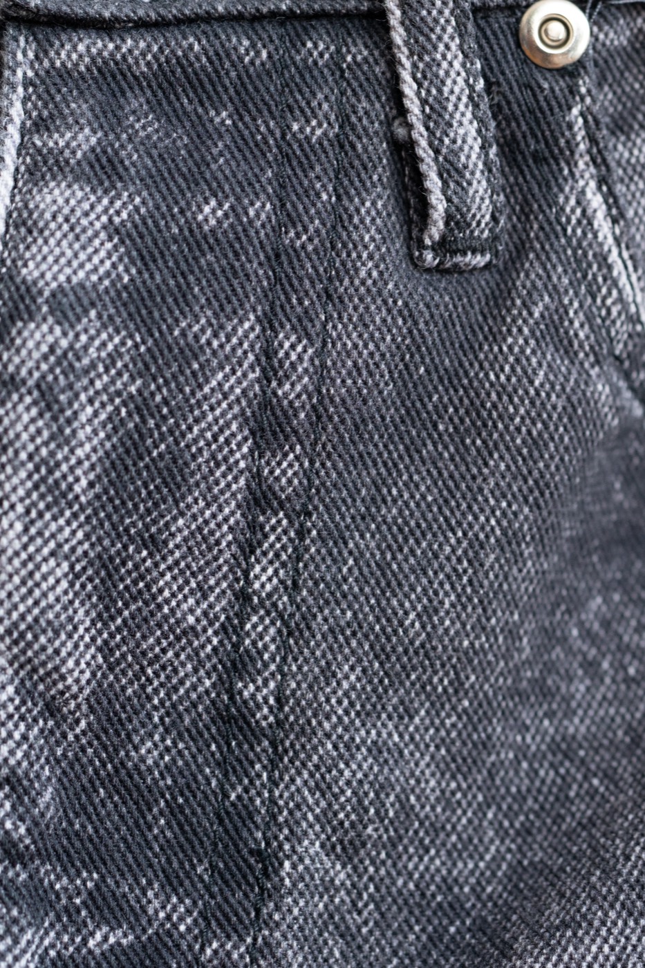 Black faded denim sample — produced without sulphur dye, whiskers, hand sanding, PP spray, intensive washing, or lasers
